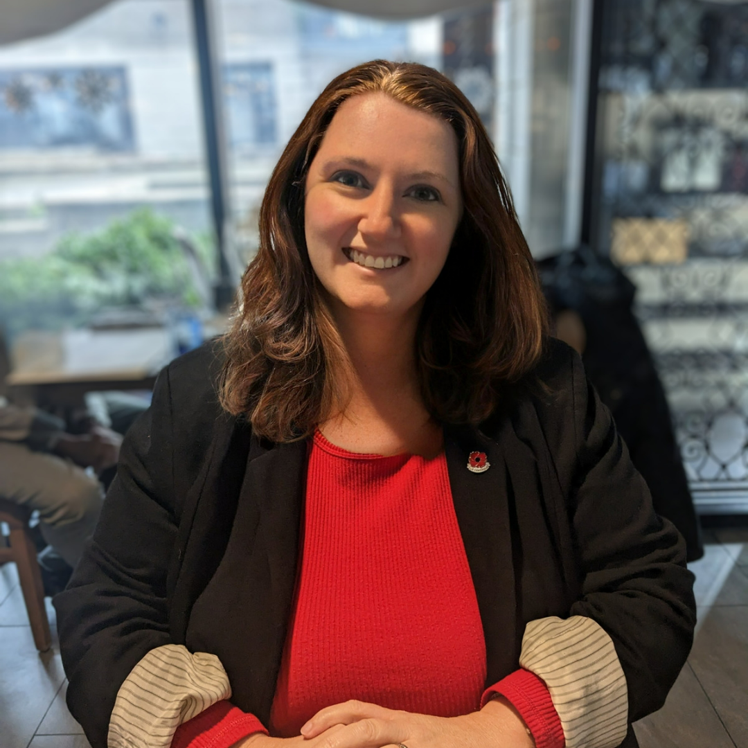 Dr. Racquel Hines Lynch, founder of Hines Lynch Lab, smiling in a café